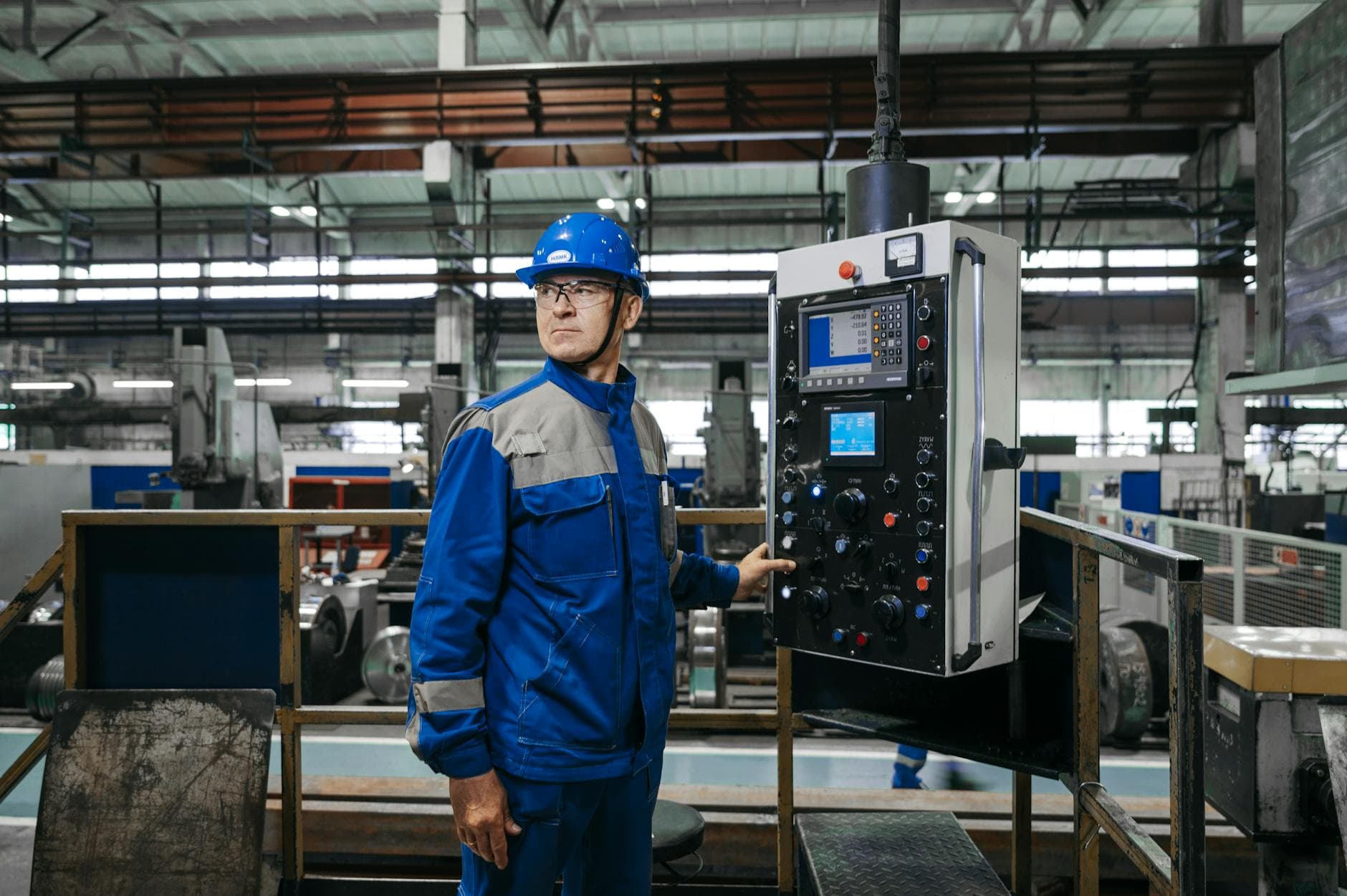 A worker on a manufacturing floor — Singapore's industries face a 15% workforce shortfall that AI is meant to close.