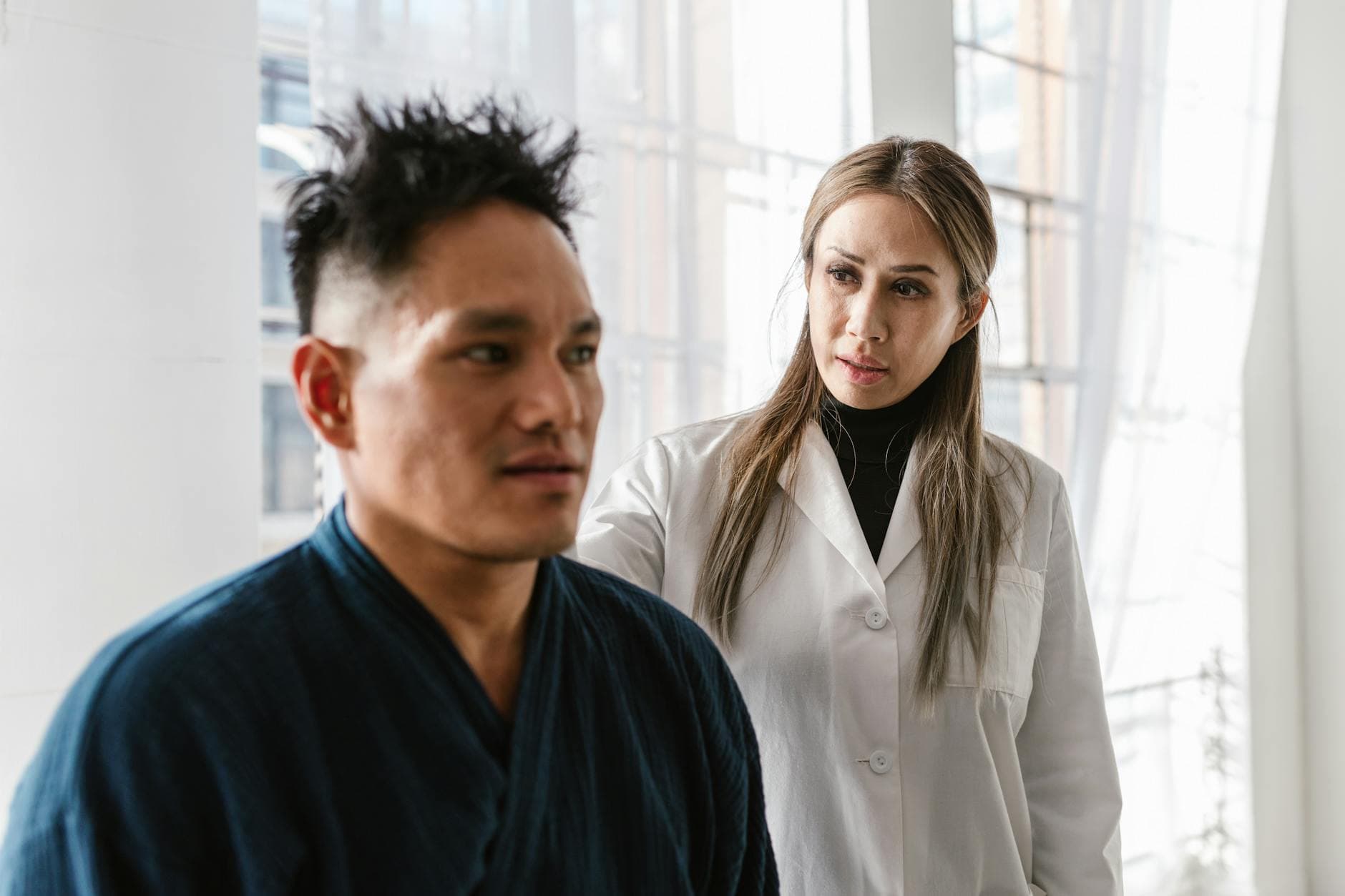 A doctor consulting with a patient — AI clinical documentation lets clinicians focus on care, not typing.