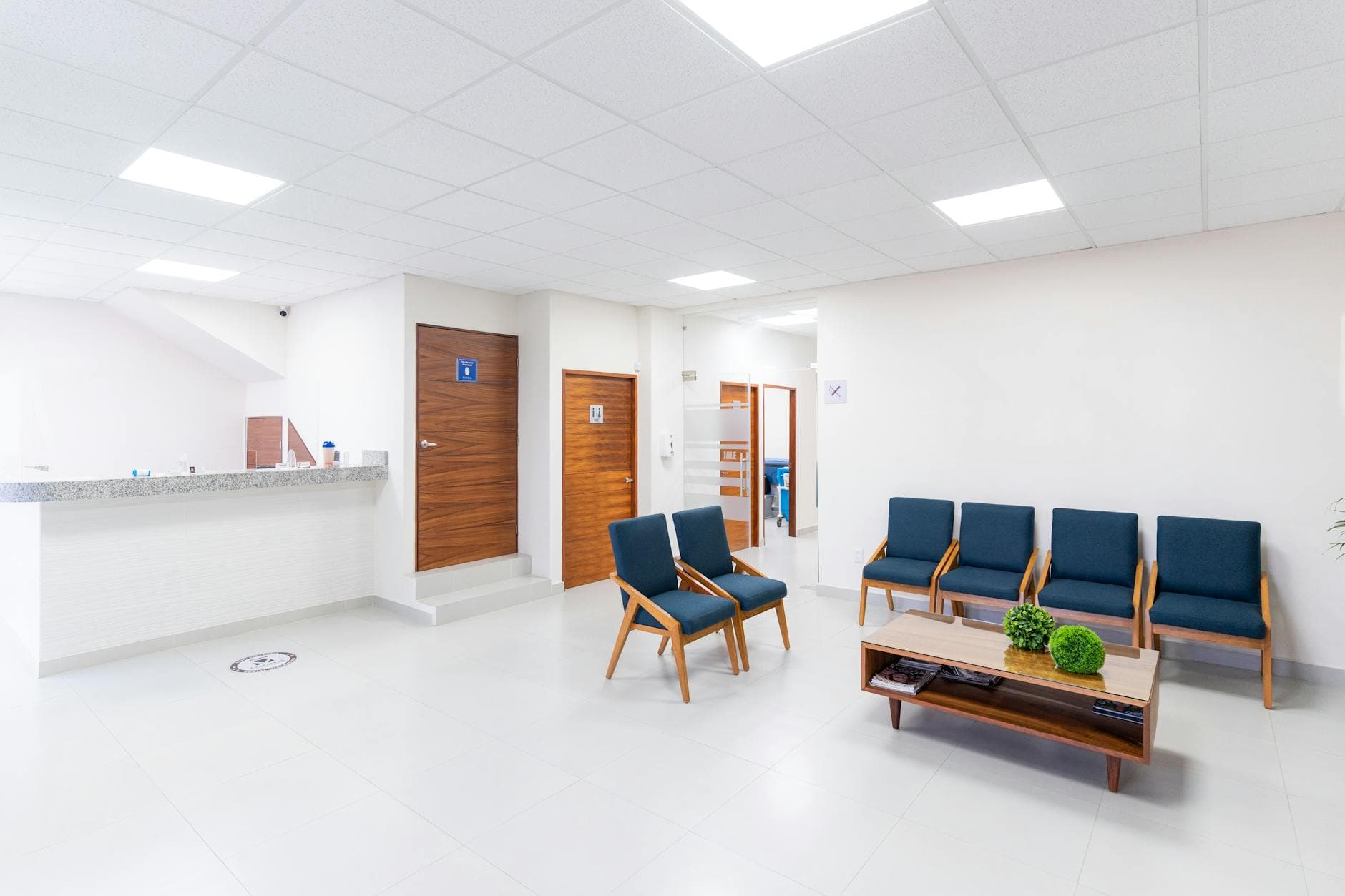 A modern clinic waiting room — Singapore polyclinics face 3-hour wait times that AI scheduling can shorten.