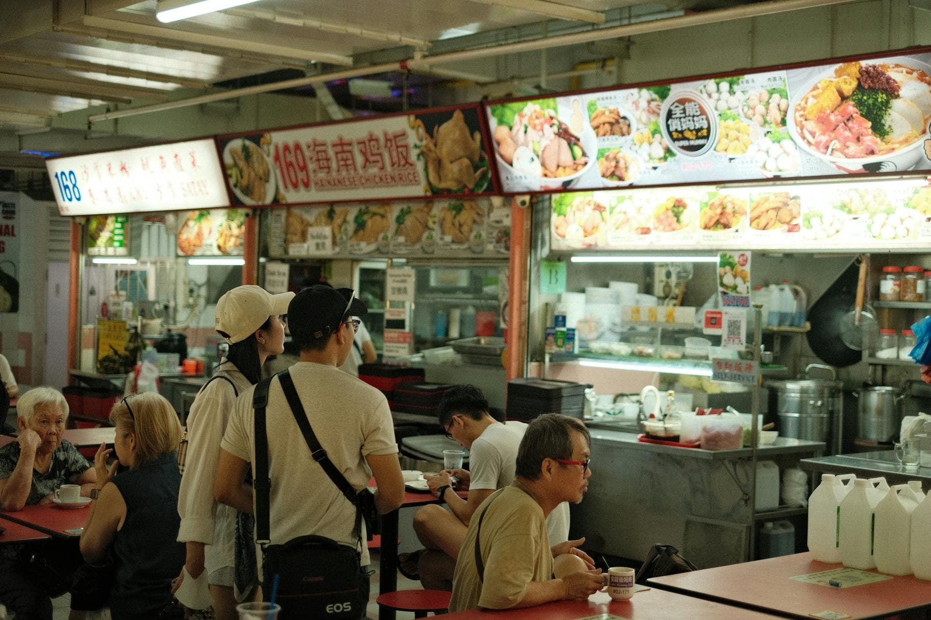 A bustling Singapore hawker centre at lunchtime — F&B is one of the four sectors targeted for AI adoption.