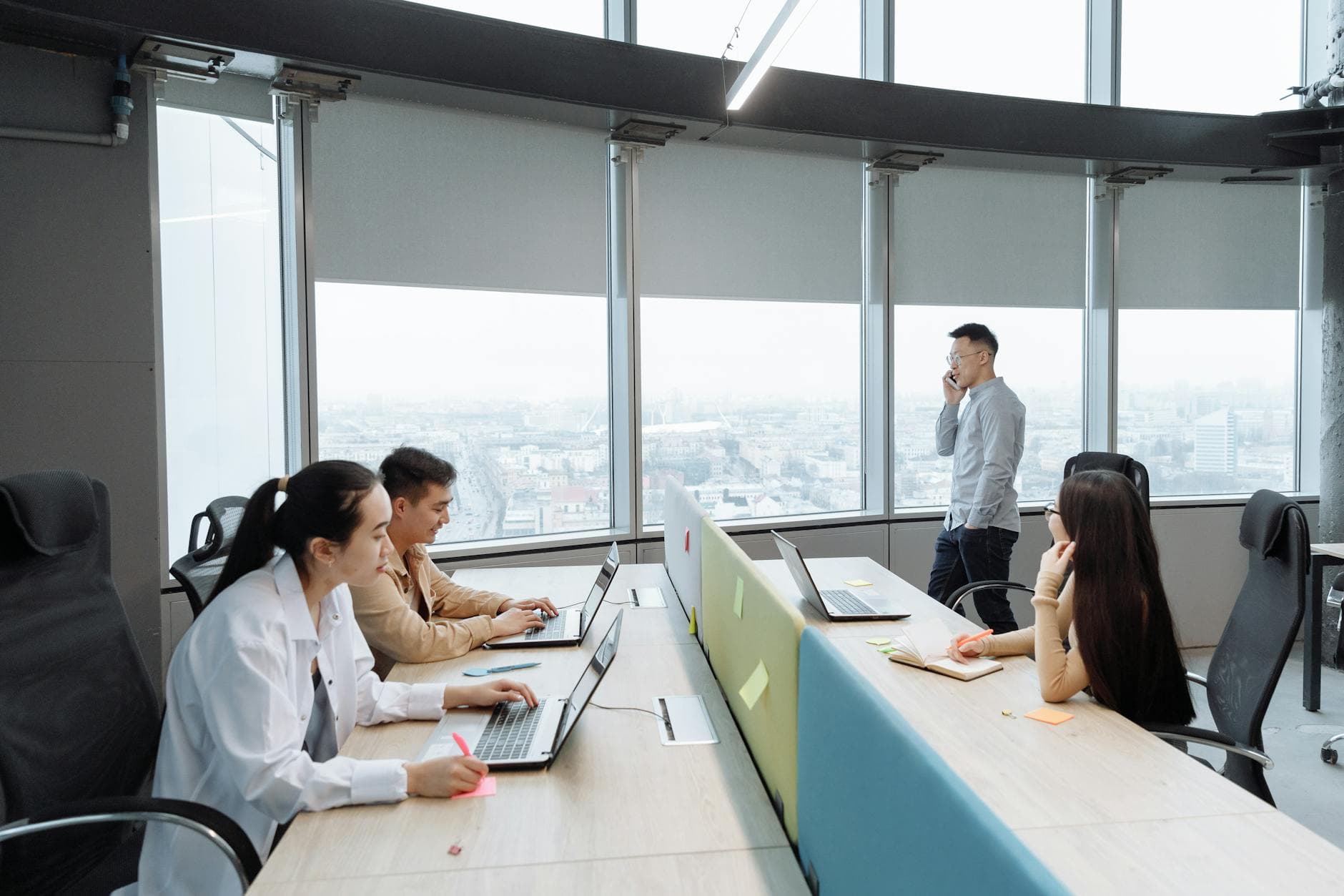 A modern Singapore office team at work — every grant on this guide is co-funding businesses just like this one.