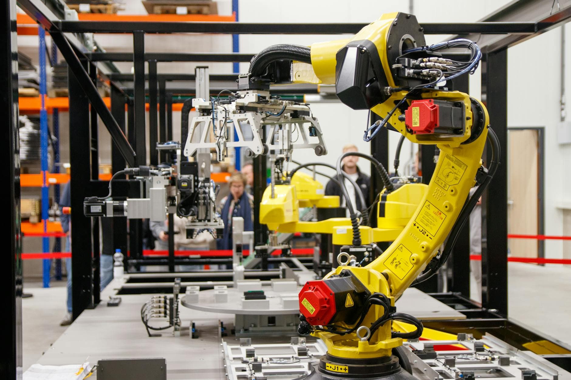 A robotic arm in a manufacturing line — Singapore's manufacturing sector is short 15% of its workforce.