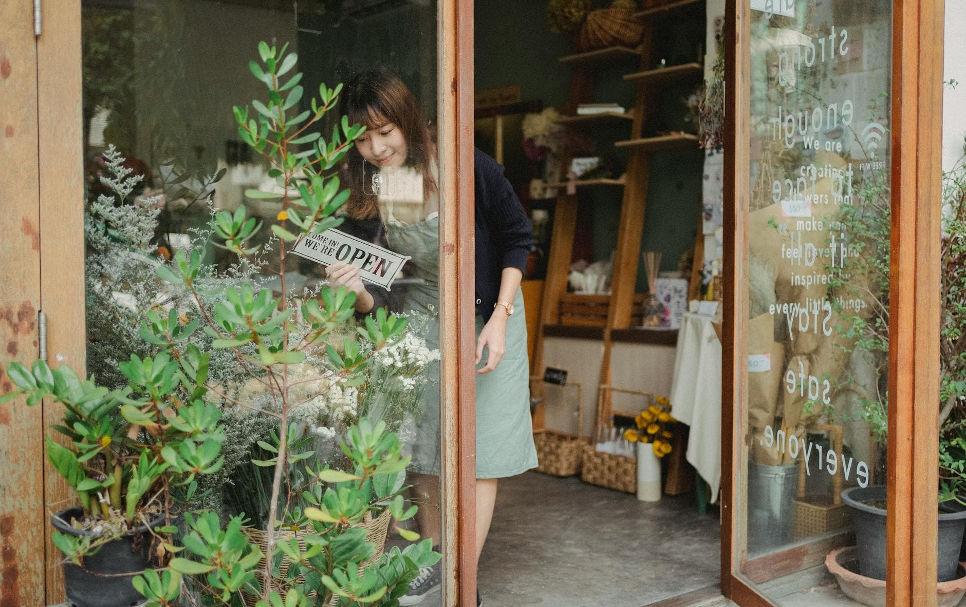 A small retail shop owner attending to a customer — service SMEs are a core SGAI client segment.